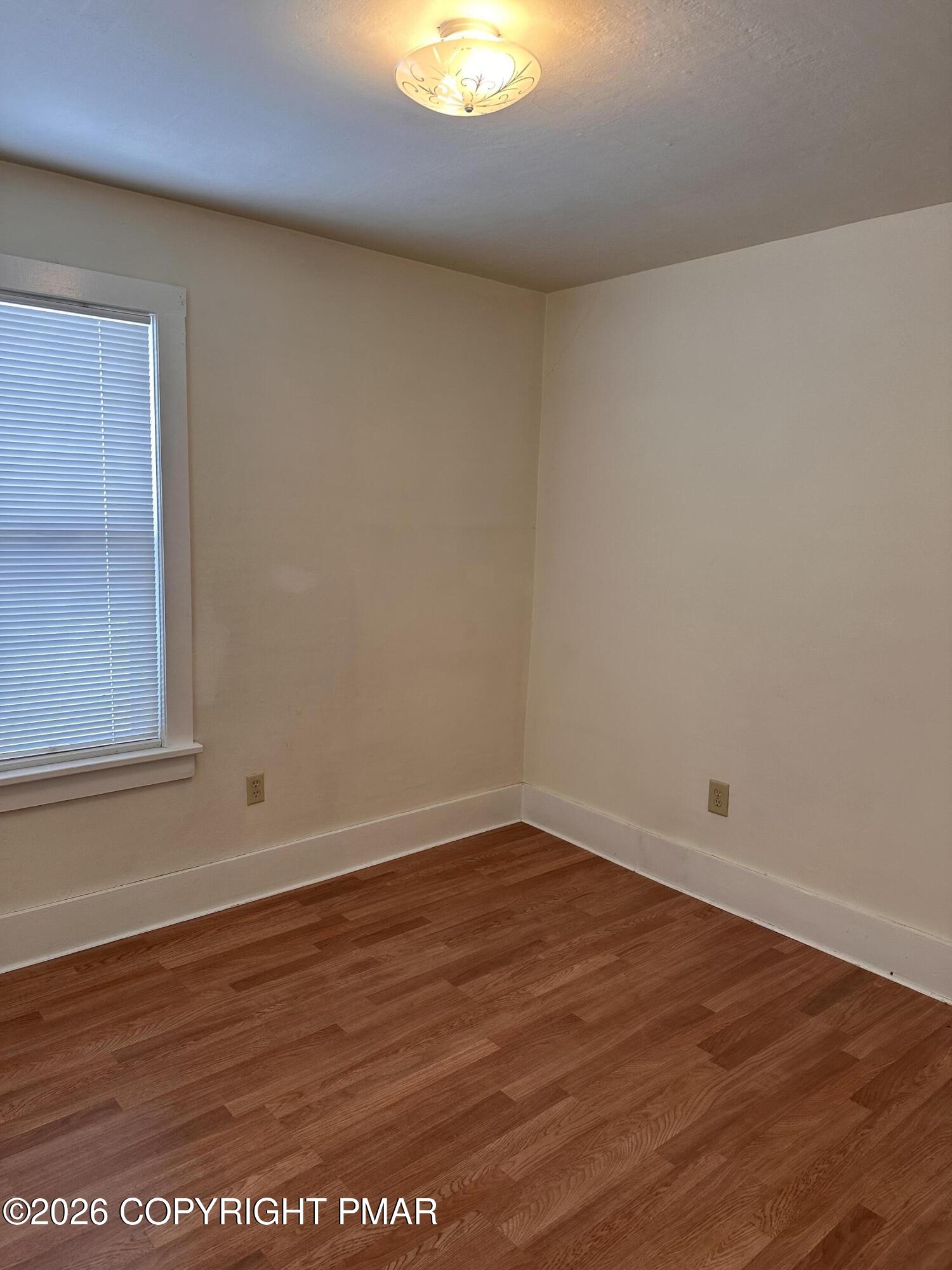 142 Craigs Meadow Road East Stroudsburg, PA 18301 - Photo 13 of 23 an empty room with wooden floor and windows