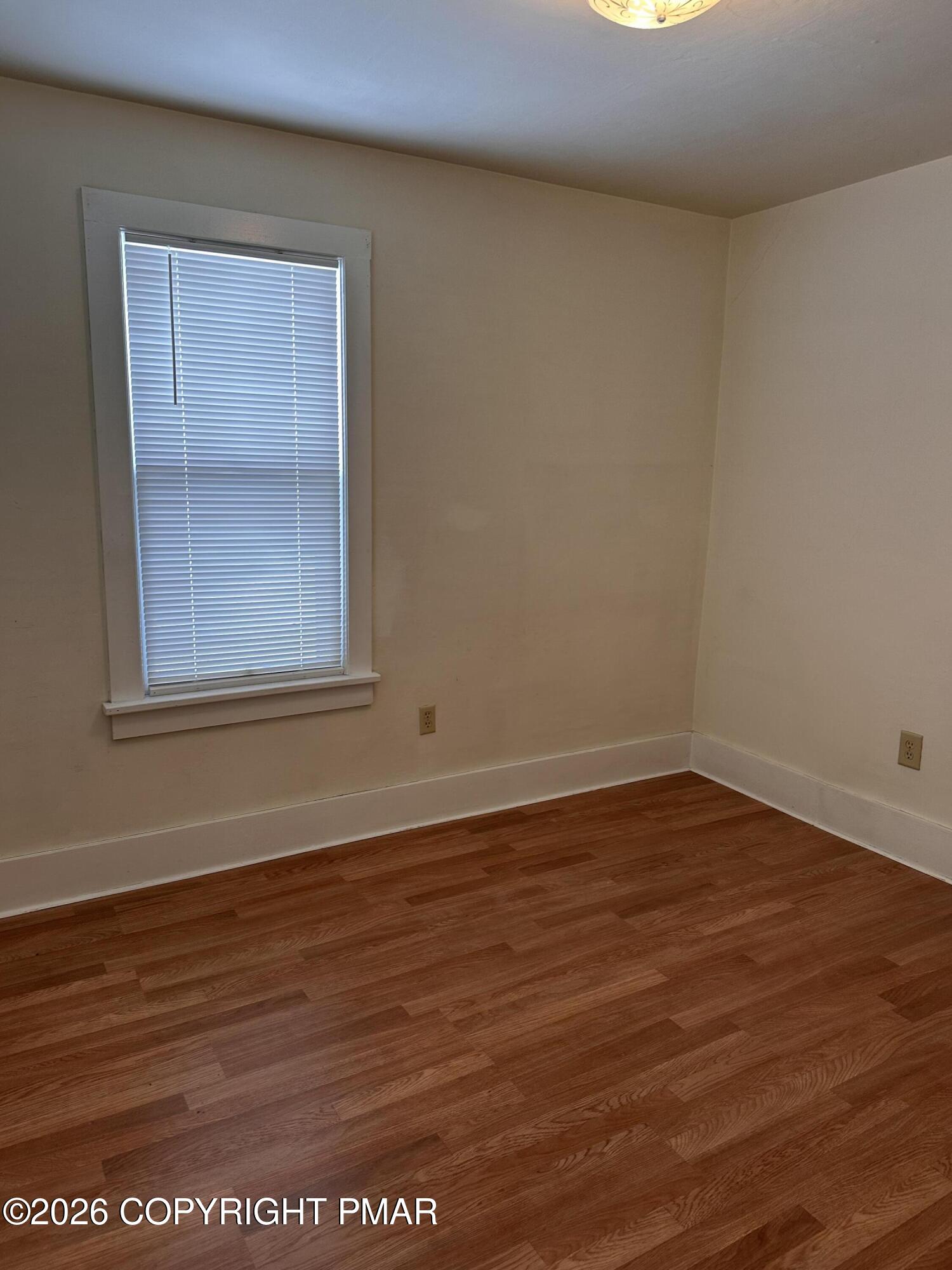 142 Craigs Meadow Road East Stroudsburg, PA 18301 - Photo 14 of 23 an empty room with wooden floor and windows