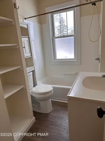 a bathroom with a sink a toilet and a shower