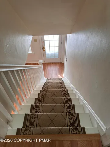 a view of entryway with wooden floor