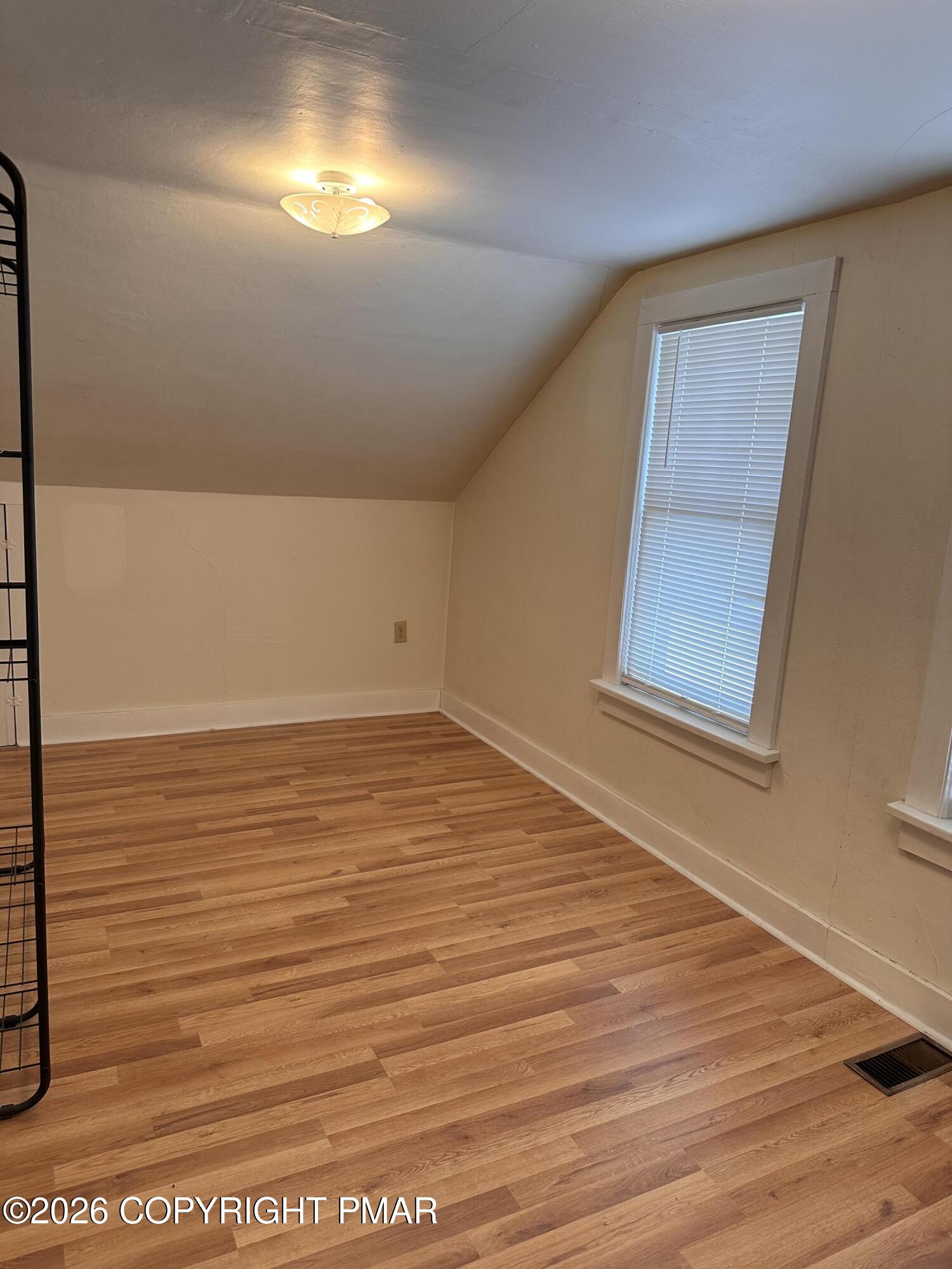 142 Craigs Meadow Road East Stroudsburg, PA 18301 - Photo 18 of 23 a view of an empty room with wooden floor and a window