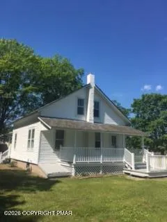 a front view of a house with a yard table and chairs