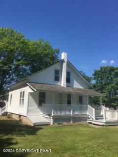 142 Craigs Meadow Road East Stroudsburg, PA 18301 - Photo 3 of 23 a front view of a house with a yard table and chairs