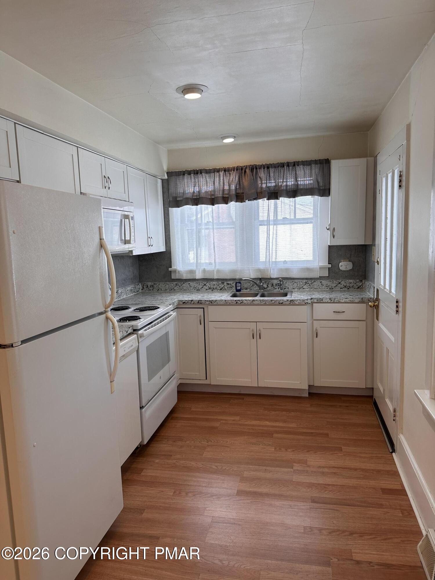 142 Craigs Meadow Road East Stroudsburg, PA 18301 - Photo 5 of 23 a kitchen with a white cabinets and white appliances