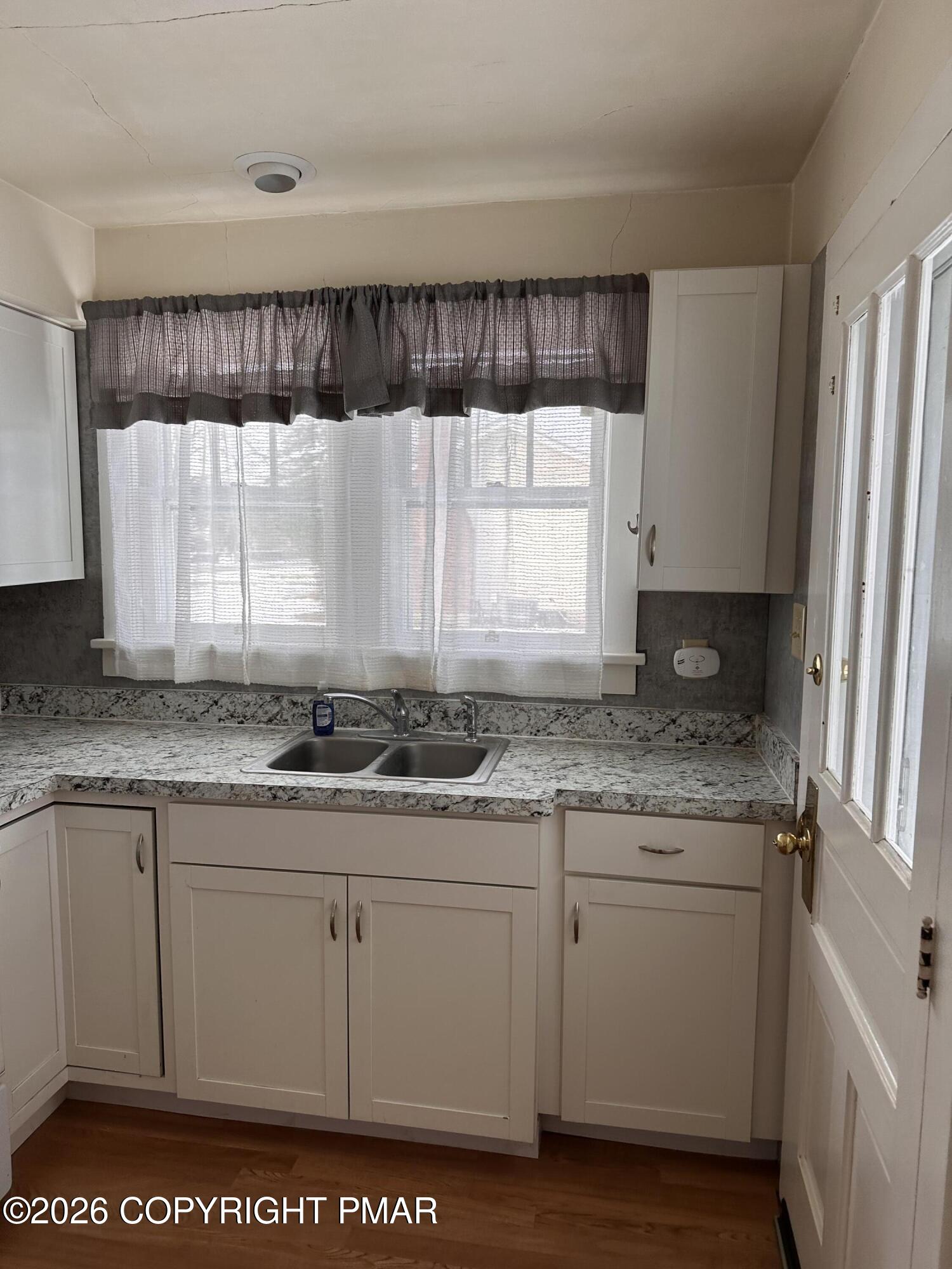 142 Craigs Meadow Road East Stroudsburg, PA 18301 - Photo 7 of 23 a kitchen with granite countertop a sink cabinets and window