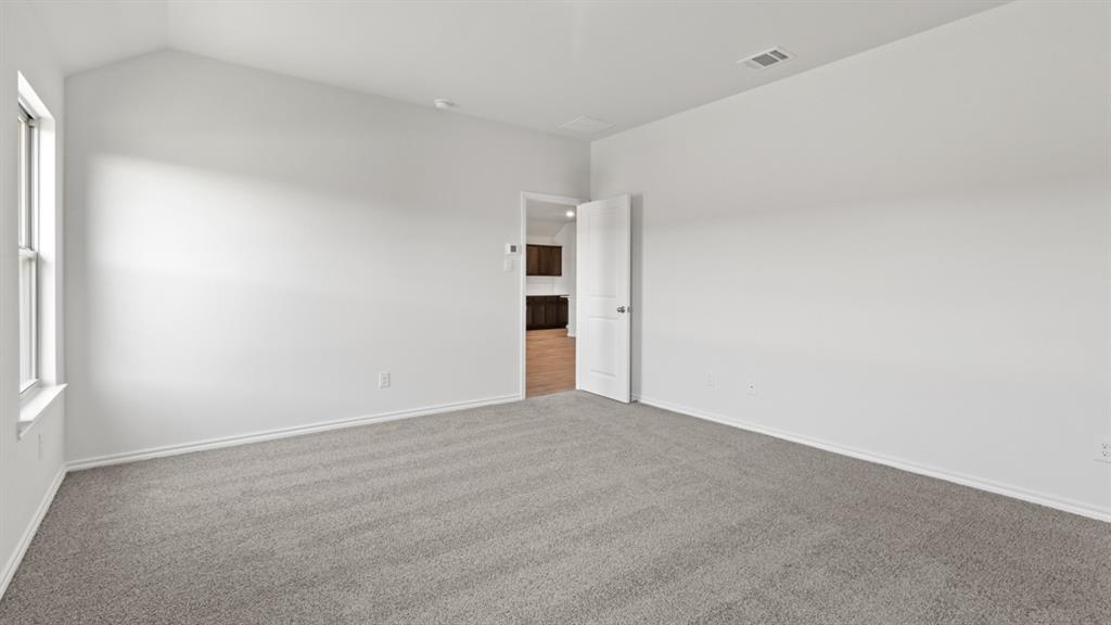 1913 Reveille Way Terrell, TX 75160 - Photo 16 of 35 Unfurnished room with carpet floors and vaulted ceiling