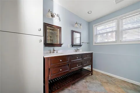 a bathroom with a sink vanity and mirror