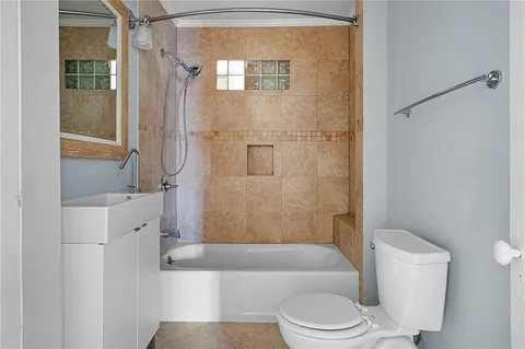 a bathroom with a toilet a sink and bathtub