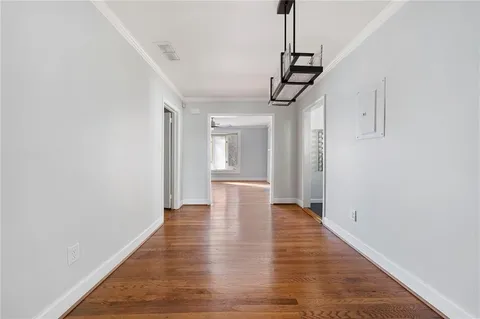 a view of a hallway with wooden floor