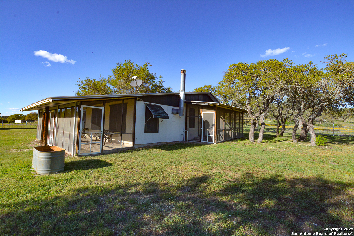 482 Wingert Road Junction, TX 76849 - Photo 12 of 61 a front view of a house with a garden