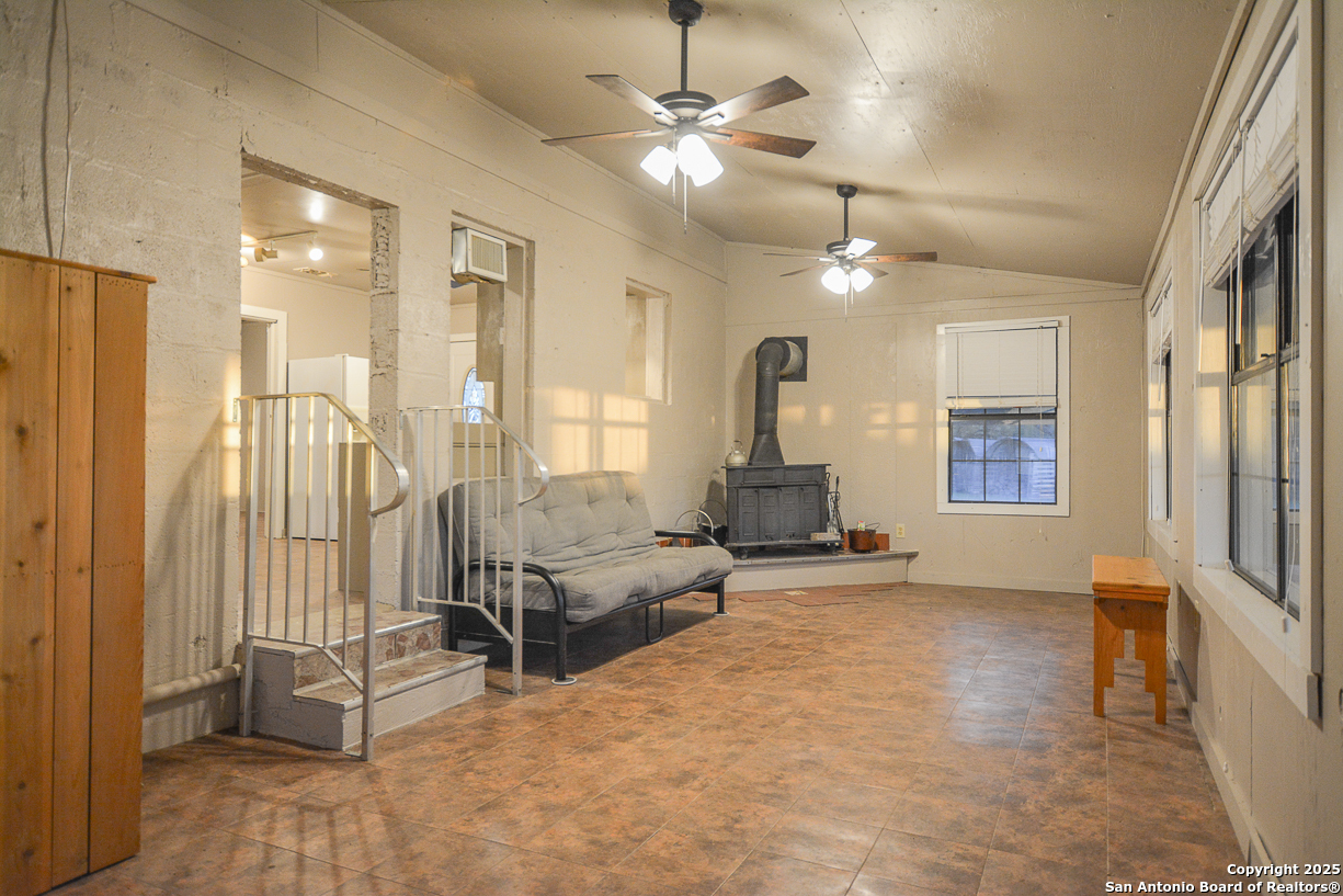 482 Wingert Road Junction, TX 76849 - Photo 15 of 61 a living room with furniture and a chandelier