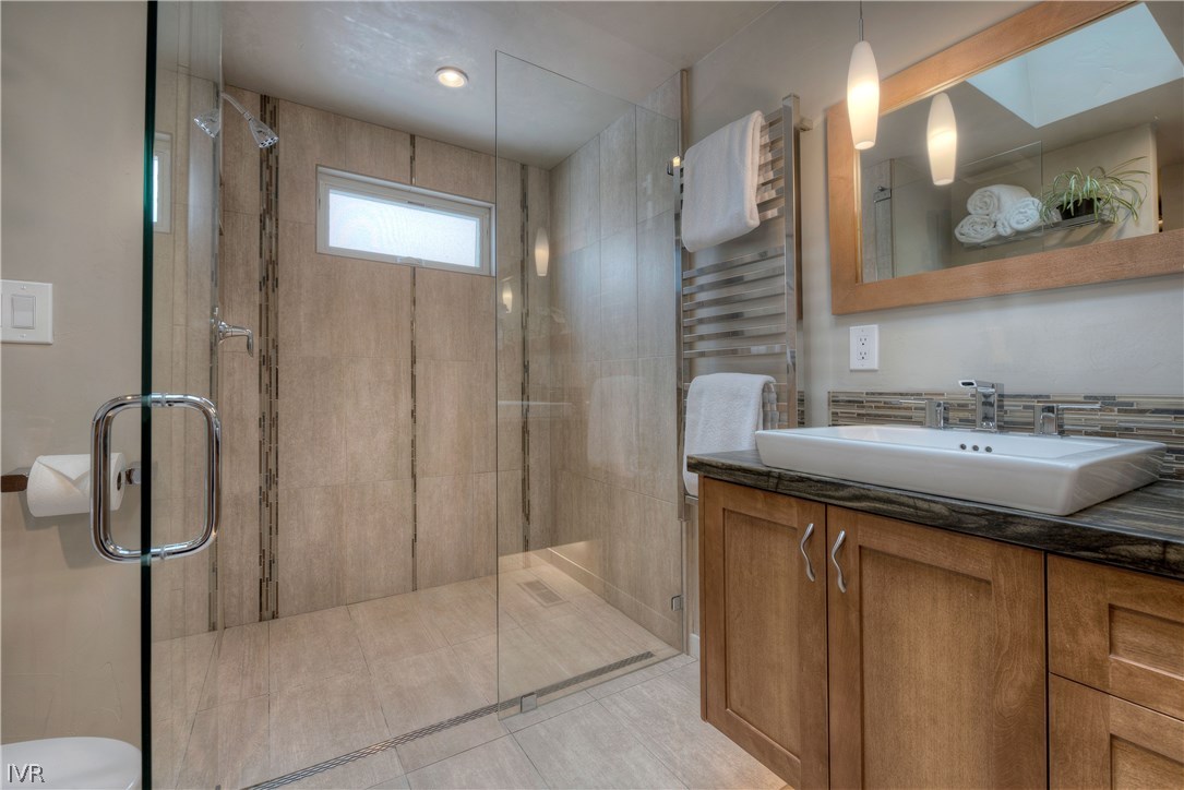 14695 Rim Rock Drive Reno, NV 89521 - Photo 17 of 30 a bathroom with a granite countertop sink a mirror and shower