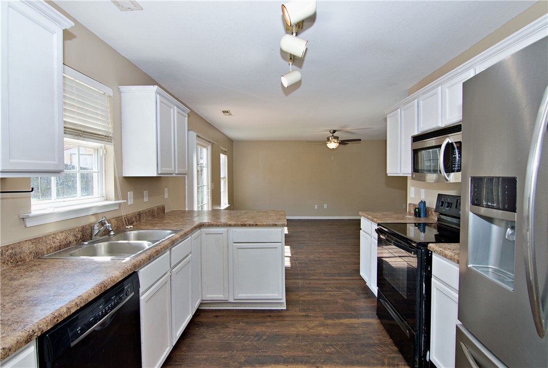 305 North Chestnut Street Seneca, SC 29678 - Photo 12 of 44 A well-equipped kitchen offers ample counter space and a seamless flow into the living area.