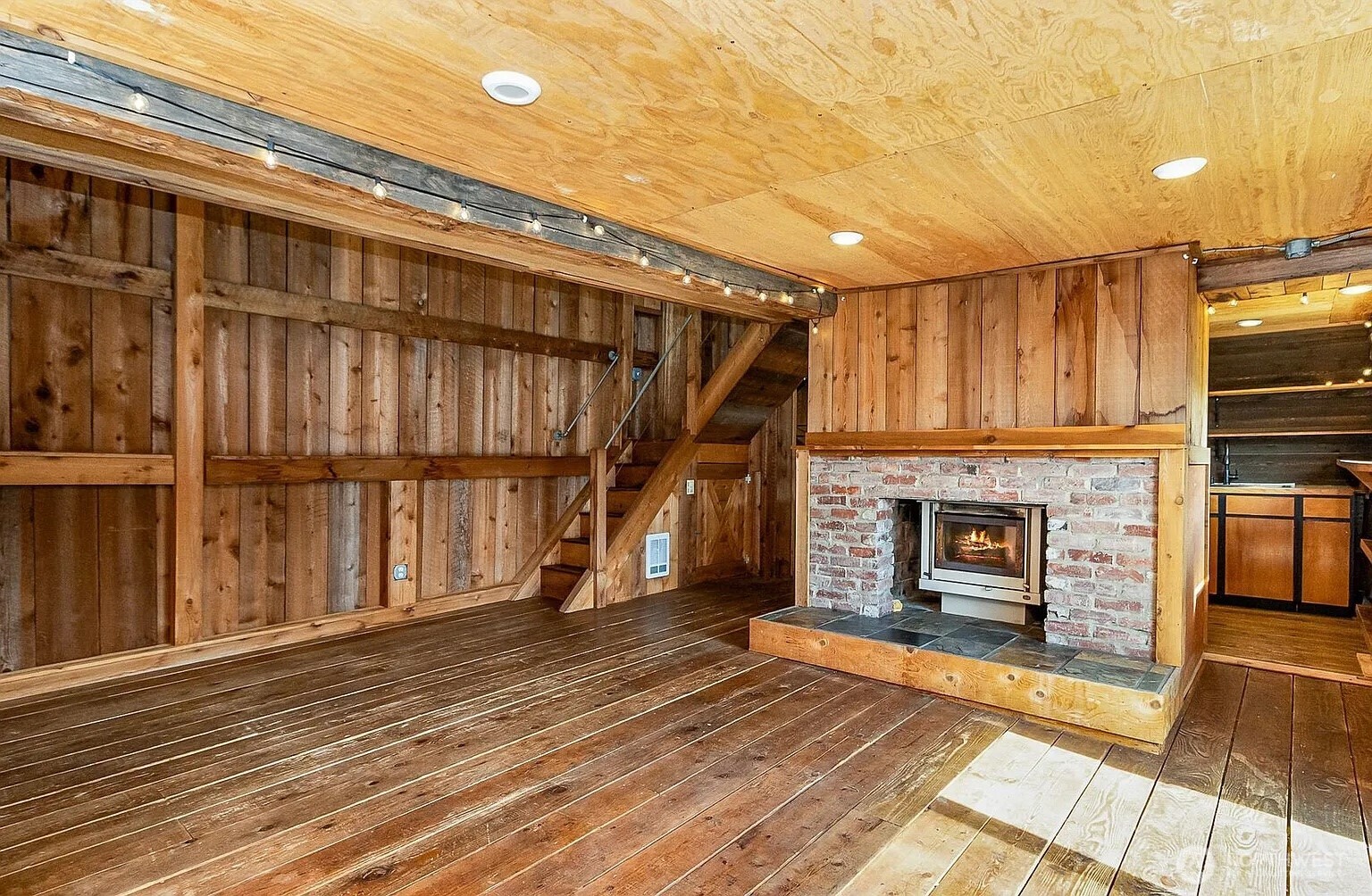 1103 Southwest Roesiger Road Snohomish, WA 98290 - Photo 13 of 32 a view of a livingroom with wooden floor and a staircase