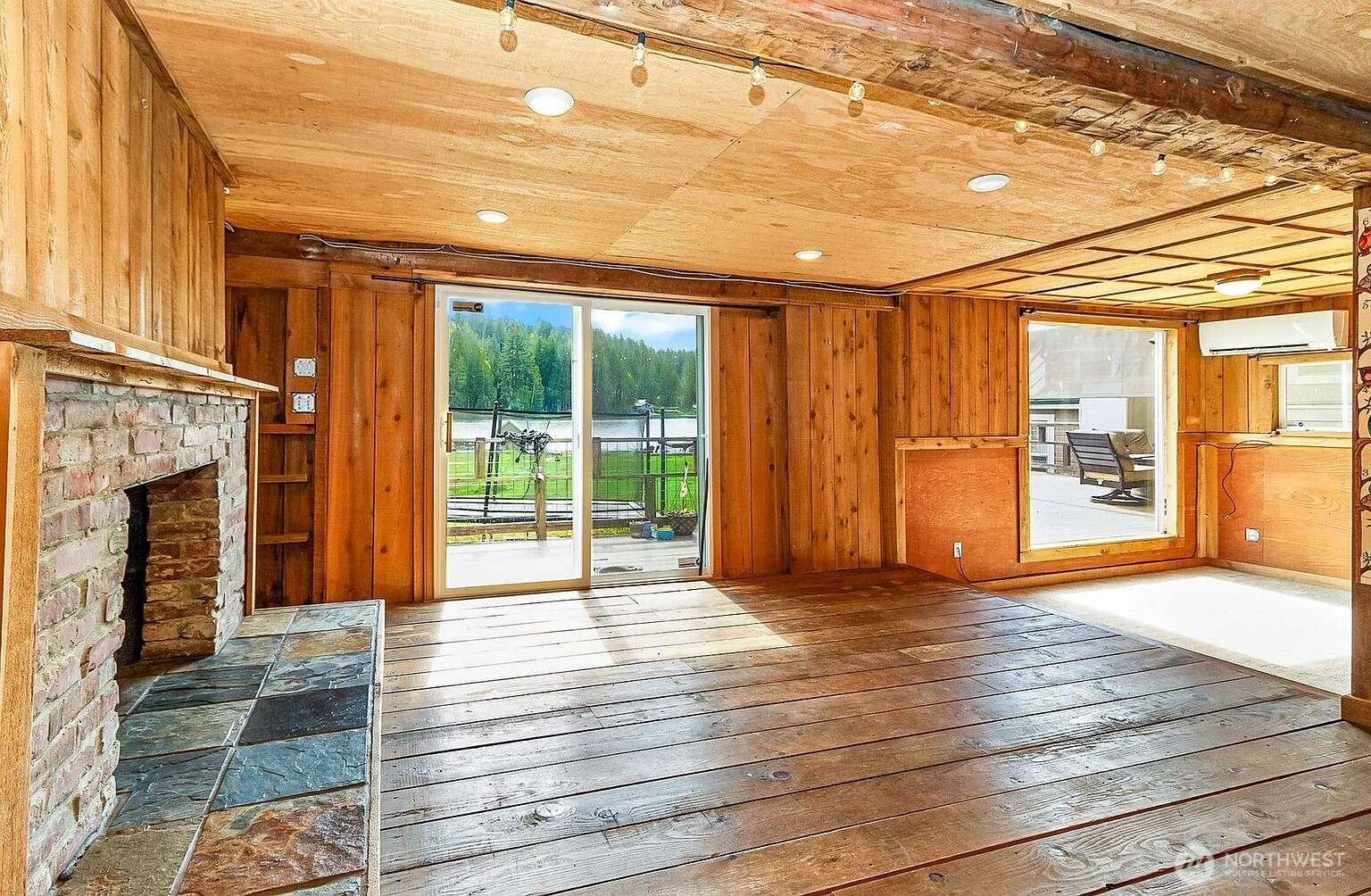 1103 Southwest Roesiger Road Snohomish, WA 98290 - Photo 5 of 32 a view of an empty room with wooden floor and a fireplace