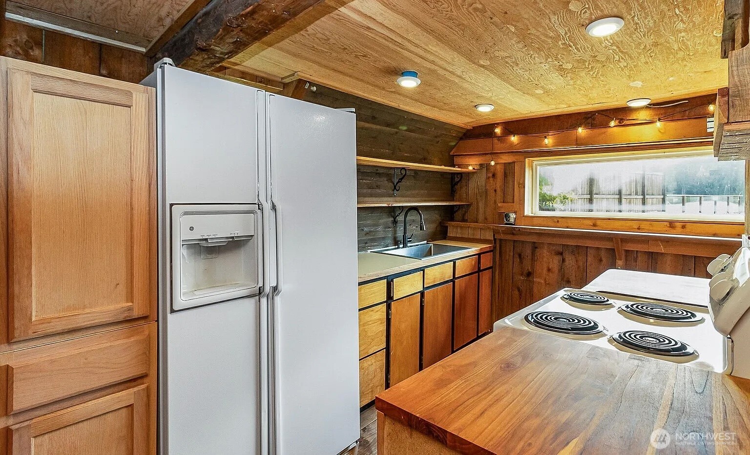 1103 Southwest Roesiger Road Snohomish, WA 98290 - Photo 6 of 32 a kitchen with stainless steel appliances a refrigerator and a stove