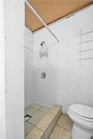 a bathroom with a toilet and shower