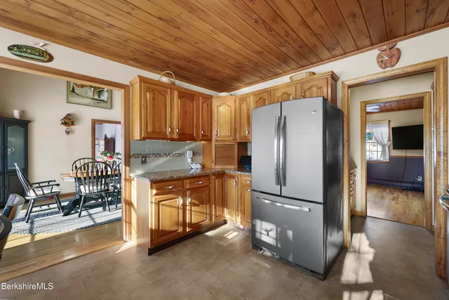 a kitchen with stainless steel appliances granite countertop a refrigerator and a stove