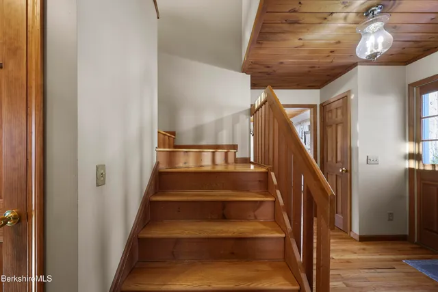a view of staircase with wooden floor and a window
