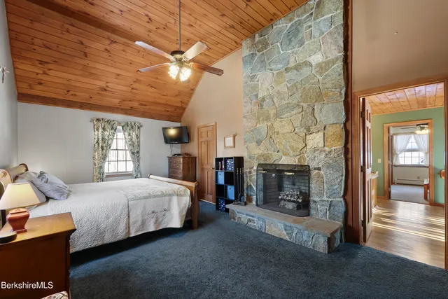 a bedroom with a bed and dresser with mirror