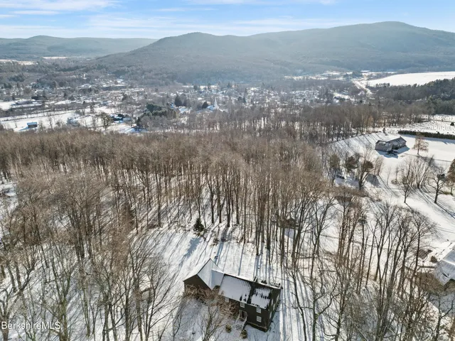 a view of a house with a snow in the yard