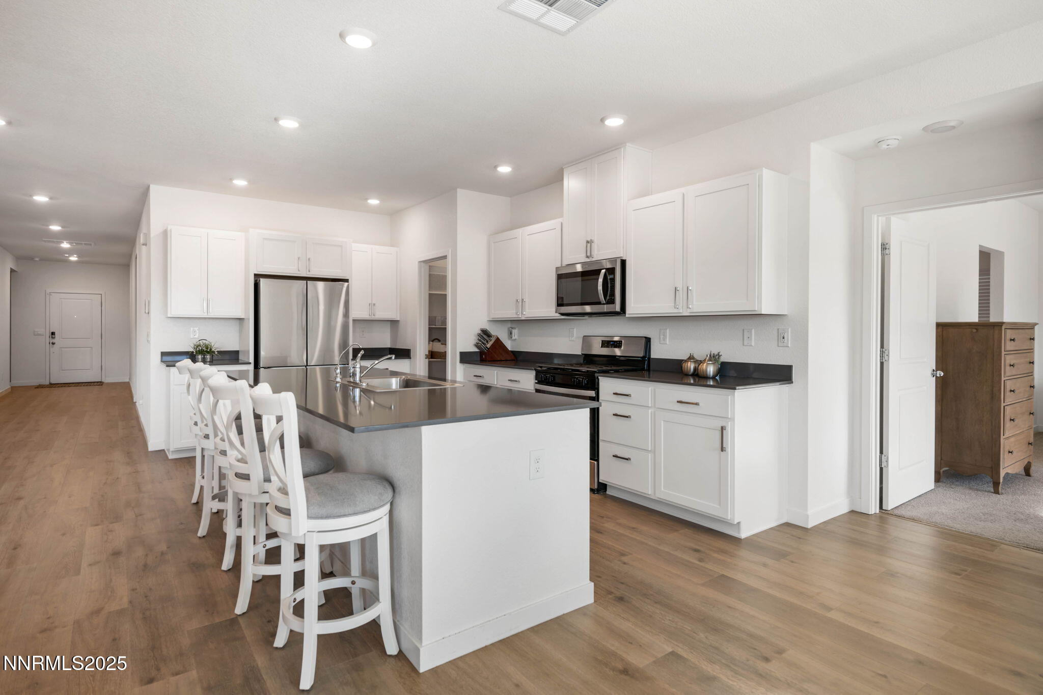 707 Butte Crk Road Dayton, NV 89403 - Photo 15 of 50 a kitchen with white cabinets stainless steel appliances and sink