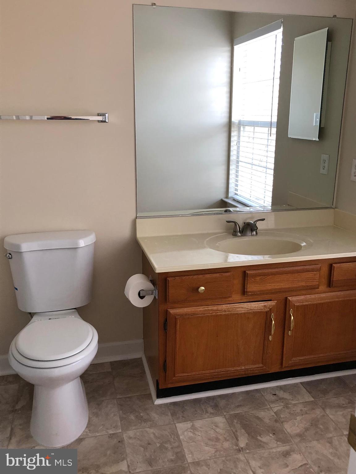 6412 View Point Court Frederick, MD 21703 - Photo 15 of 38 a bathroom with a granite countertop toilet sink and mirror