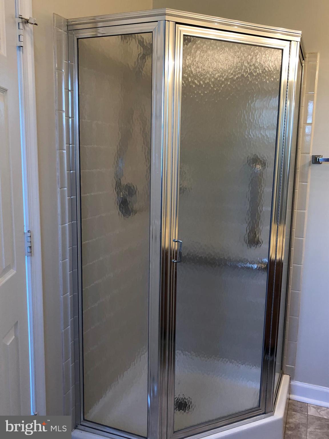6412 View Point Court Frederick, MD 21703 - Photo 21 of 38 a bathroom with a glass shower door