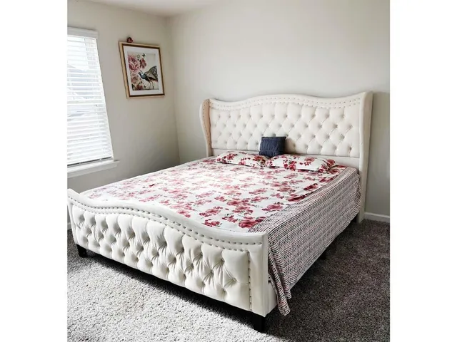 a living room with a bed and window