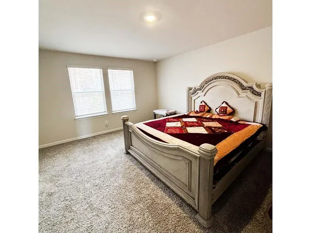 a bathroom with double vanity and a mirror