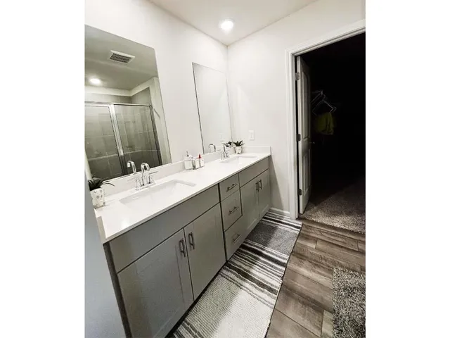 a bathroom with a glass shower door