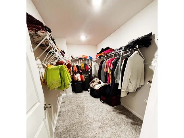 a view of a house with backyard and chairs