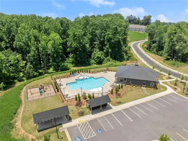 a view of a patio with table and chairs potted plants and large tree
