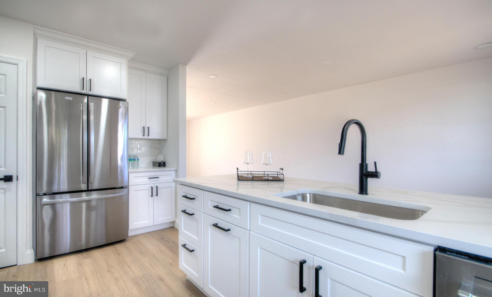 924 Cropwell Road Cherry Hill, NJ 08003 - Photo 44 of 76 a kitchen with stainless steel appliances kitchen island a refrigerator sink and cabinets