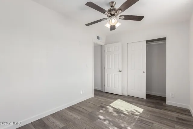 an empty room with fan and a ceiling fan