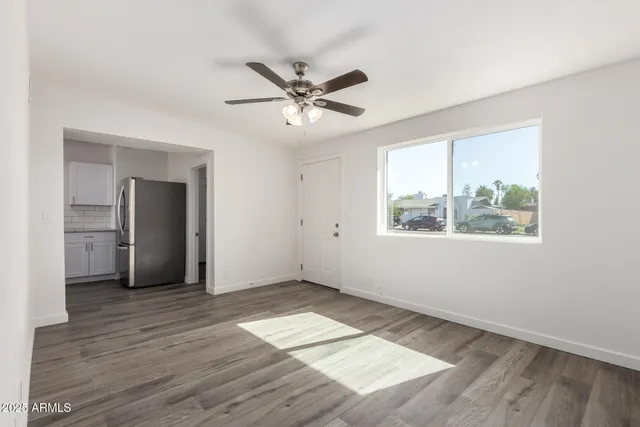 wooden floor in an empty room with a window