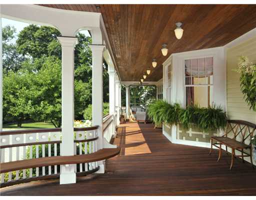 79 Bush Avenue Greenwich, CT 06830 - Photo 3 of 19 a view of a patio with table and chairs potted plants and large tree