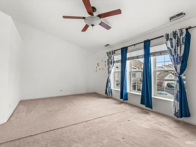 an empty room with windows and entrance