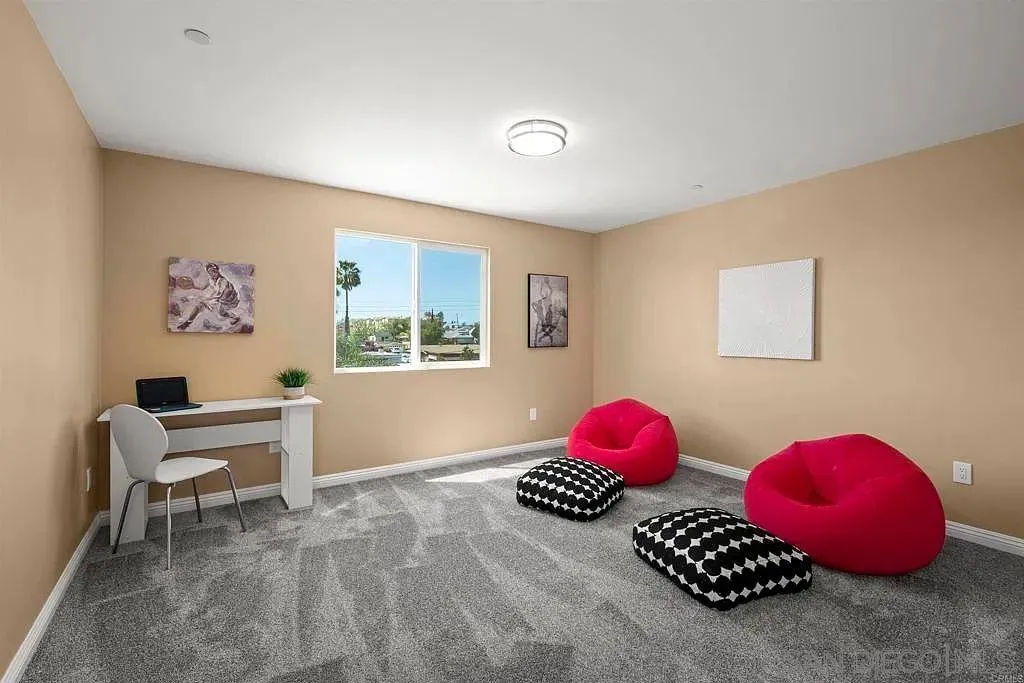 909 Concepcion Avenue Spring Valley, CA 91977 - Photo 20 of 27 a bedroom with a bed and a chair