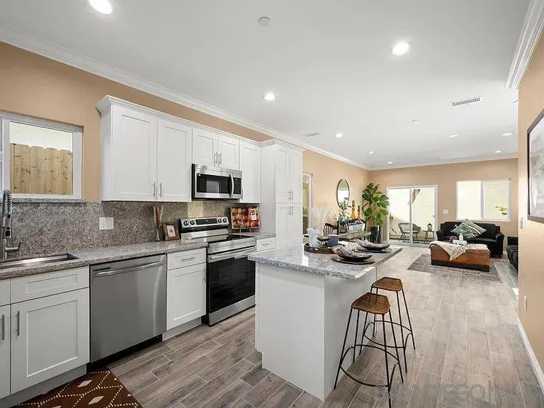 909 Concepcion Avenue Spring Valley, CA 91977 - Photo 8 of 27 a kitchen with stainless steel appliances granite countertop a sink and stove