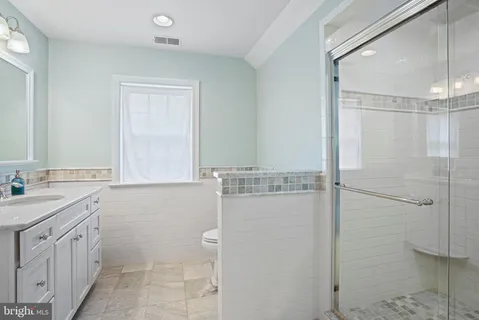 a bathroom with a shower sink and mirror