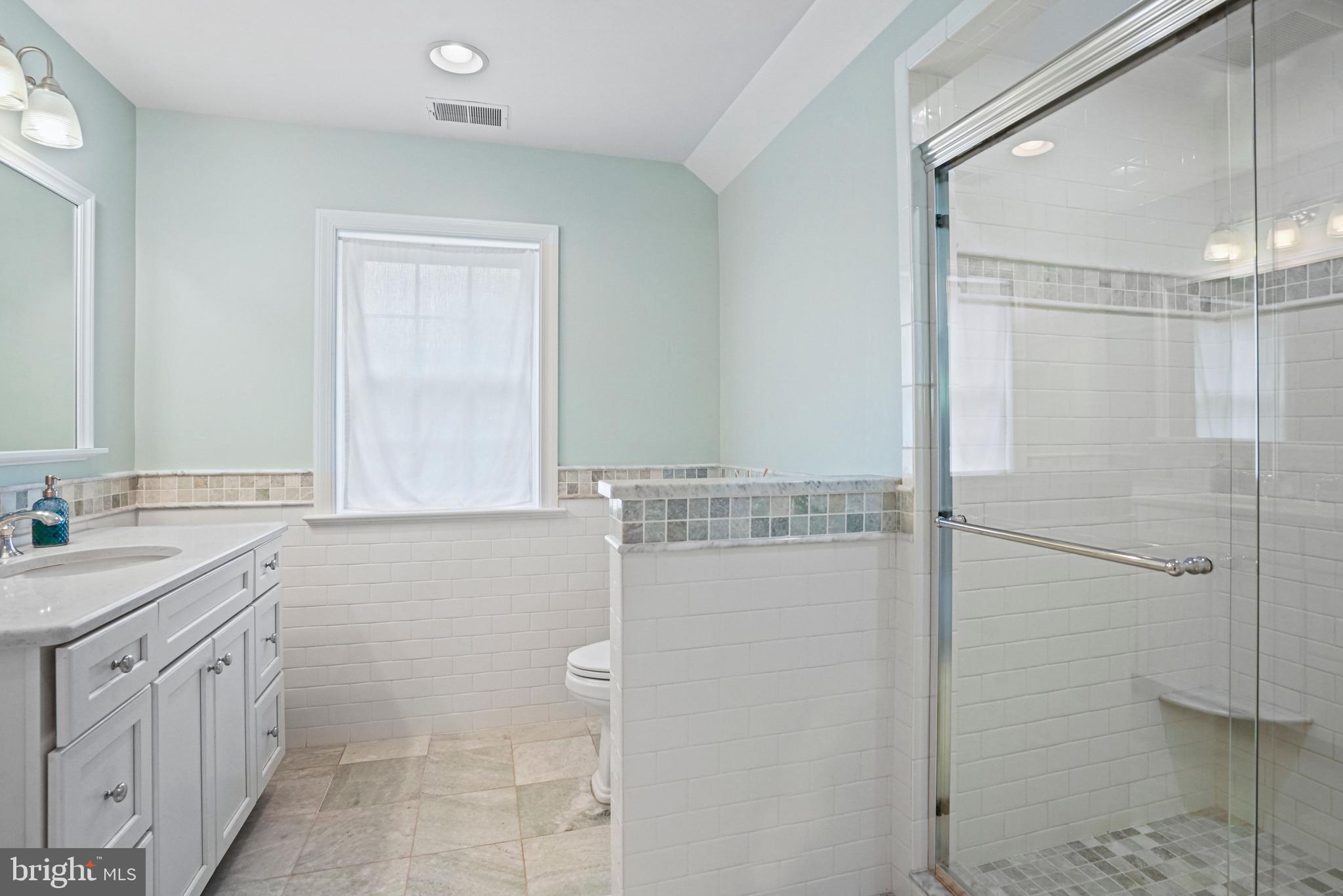 1907 Brisbane Street Silver Spring, MD 20902 - Photo 21 of 39 a bathroom with a shower sink and mirror