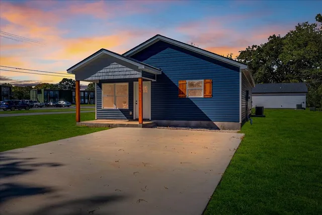 a front view of house with yard and green space