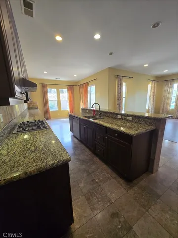 a kitchen with stainless steel appliances granite countertop a sink counter space and cabinets