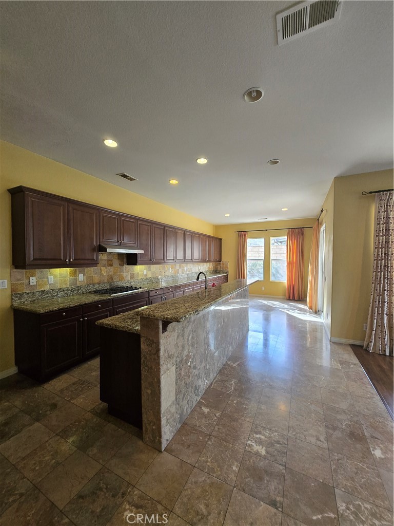 16231 Yarmouth Circle Riverside, CA 92503 - Photo 19 of 27 a kitchen with stainless steel appliances granite countertop a sink counter space and cabinets