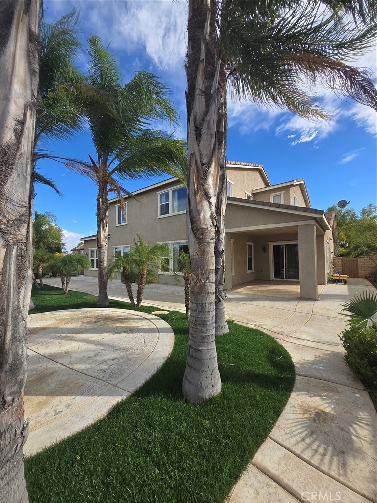 16231 Yarmouth Circle Riverside, CA 92503 - Photo 26 of 27 a front view of a house with a garden and trees