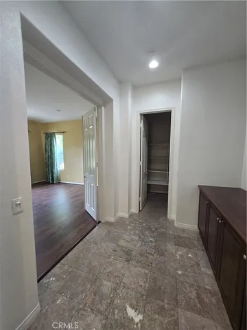 a view of livingroom with hallway and wooden floor