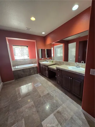 a bathroom with a sink a mirror and a shower