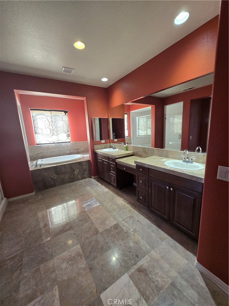 16231 Yarmouth Circle Riverside, CA 92503 - Photo 10 of 27 a large kitchen with stainless steel appliances granite countertop a sink stove and cabinets