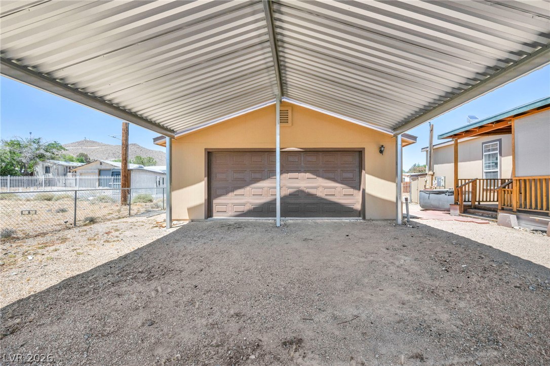 225 California Street Searchlight, NV 89046 - Photo 12 of 64 A spacious carport offers convenient, sheltered parking for vehicles or storage.